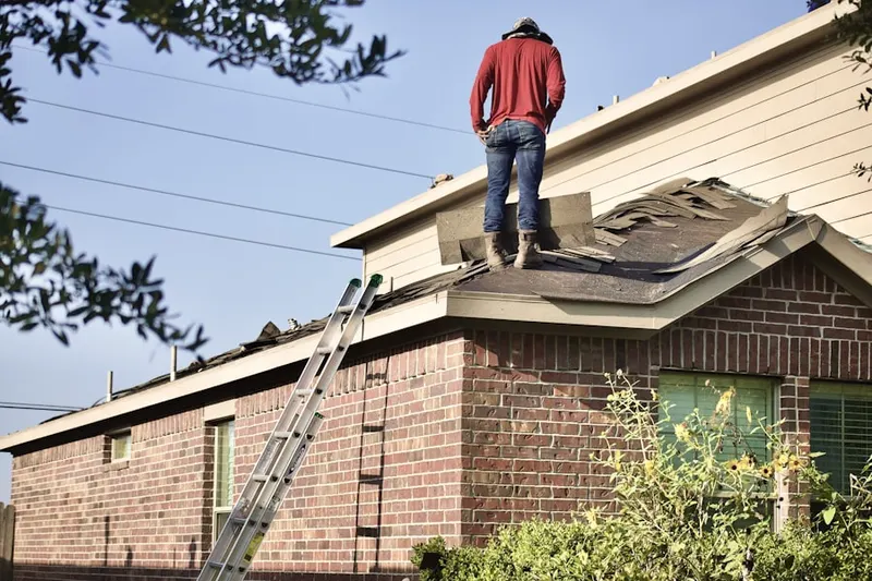 Professional roofer working on a residential roof in Bellevue